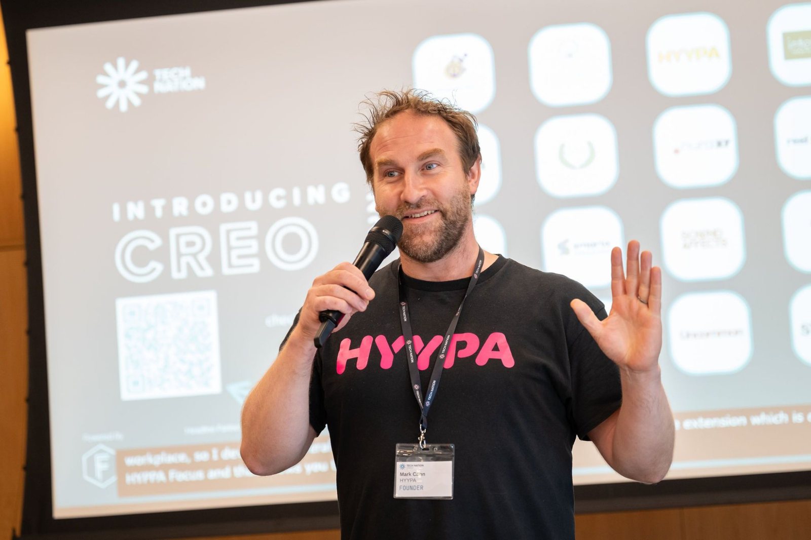 Mark Cann speaking on stage with a microphone